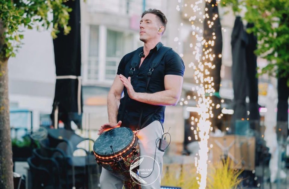 Djembe player next to a sparkler fountain during a terrace performance