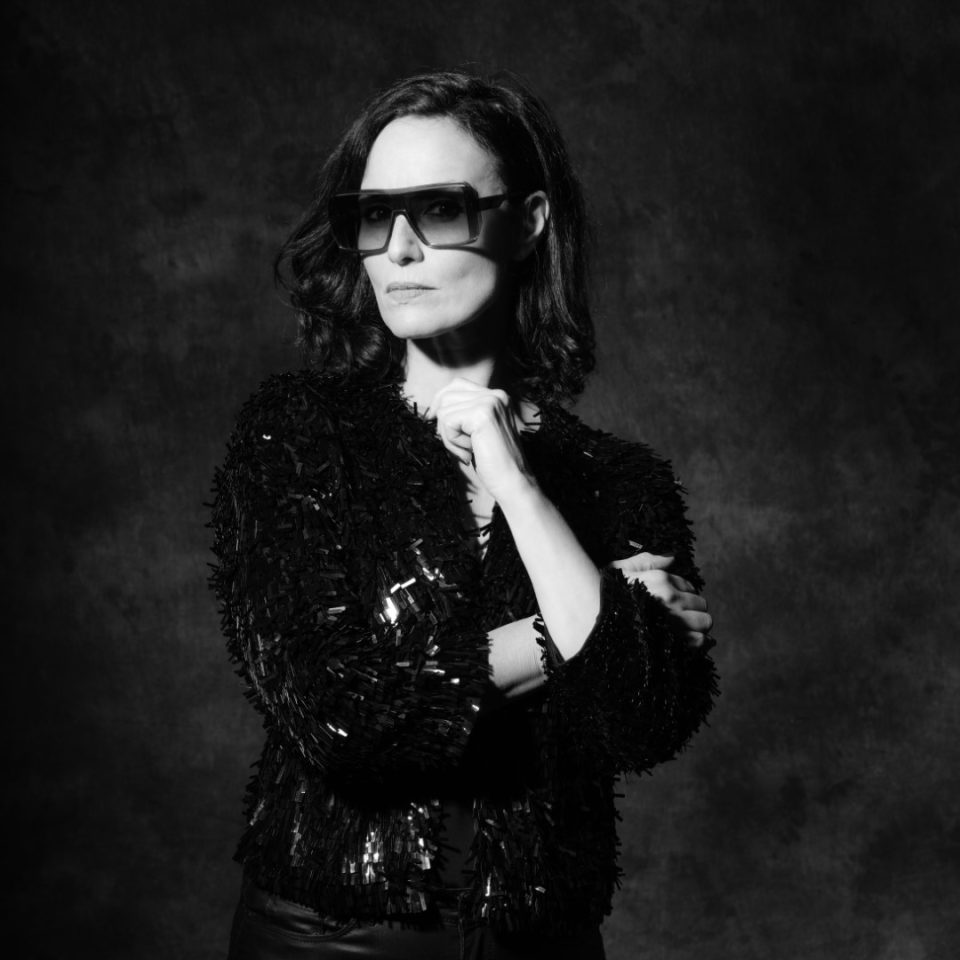 Black and white portrait of DJ Zohra in sunglasses and a sequin jacket