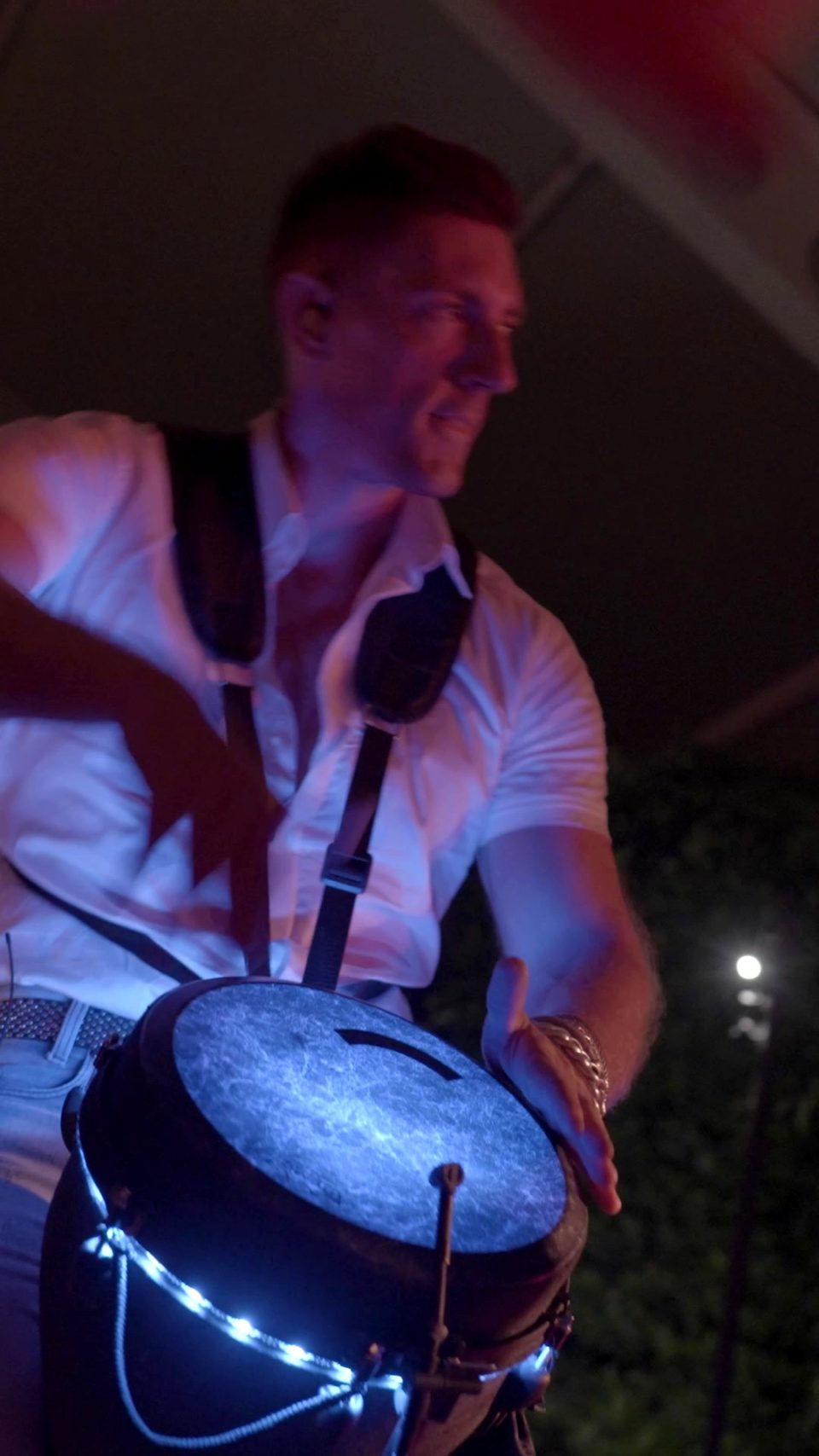 Sam Anderson playing LED djembe in the marquee of a wedding party